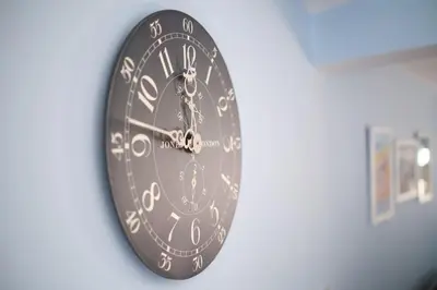a clock is hanging on a wall at Evie Cottage - The peaceful Retreat in Morecambe