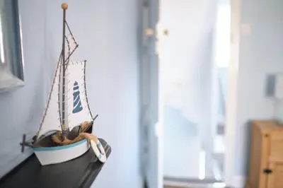 a small toy boat sitting on top of a shelf at Evie Cottage - The peaceful Retreat in Morecambe