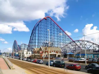 a roller coaster in a parking lot with cars at Pinnacle Hotel & Suites formerly Jean Martyn Hotel Near Central Blackpool, Near Beach & Attractions in Blackpool
