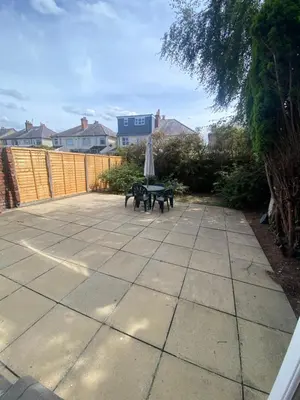 a patio with a picnic table and an umbrella at Lovely 3 bed house in Crosby in Crosby