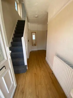 an empty hallway with stairs and a stair case at Lovely 3 bed house in Crosby in Crosby
