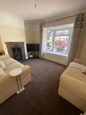 a living room with two couches and a fireplace at Lovely 3 bed house in Crosby in Crosby
