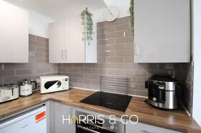 a kitchen with white cabinets and a counter top at Phoenix Rise in Fleetwood
