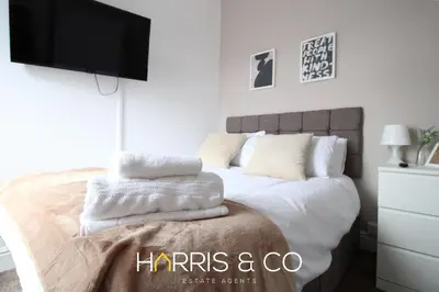 a bedroom with a bed with a flat screen tv at Phoenix Rise in Fleetwood