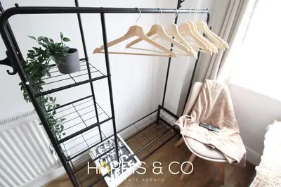 a metal rack with hangers and a chair in a room at Phoenix Rise in Fleetwood