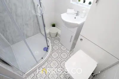 a bathroom with a shower and a toilet and a sink at Phoenix Rise in Fleetwood