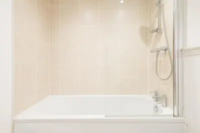 a bathroom with a bath tub with a shower at Host & Stay - The Pall Mall Apartment in Liverpool