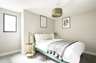 a bedroom with a bed with a black and white blanket at Host & Stay - The Pall Mall Apartment in Liverpool