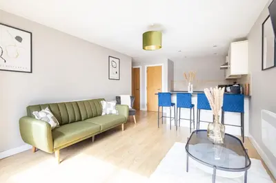 a living room with a couch and a table at Host & Stay - The Pall Mall Apartment in Liverpool
