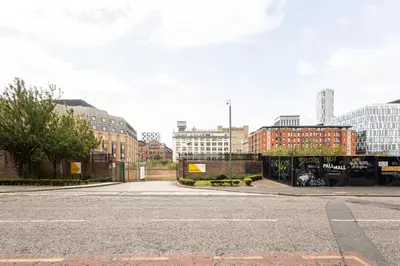 an empty street in a city with tall buildings at Host & Stay - The Pall Mall Apartment in Liverpool