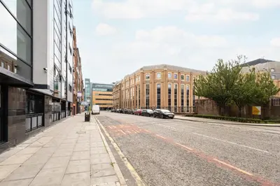 an empty street in a city with buildings at Host & Stay - The Pall Mall Apartment in Liverpool