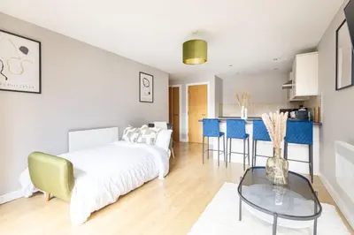 a living room with a bed and a table at Host & Stay - The Pall Mall Apartment in Liverpool