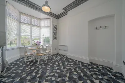 a dining room with a table and chairs at Casbah Coffee Club Suites in West Derby