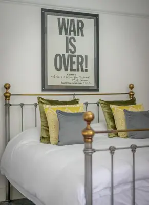 a bed with pillows and a picture on the wall at Casbah Coffee Club Suites in West Derby