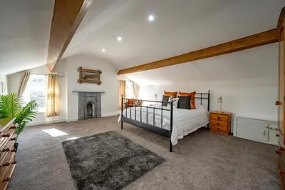 a bedroom with a bed and a fireplace at Casbah Coffee Club Suites in West Derby
