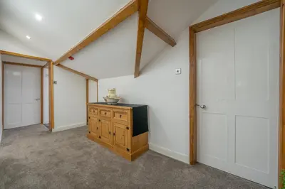 an attic room with a tv and a closet at Casbah Coffee Club Suites in West Derby