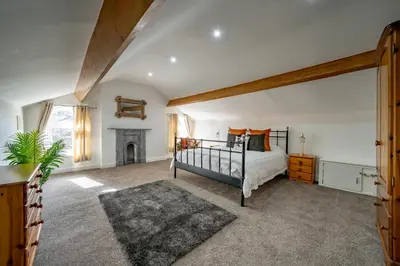 a bedroom with a bed and a fireplace at Casbah Coffee Club Suites in West Derby