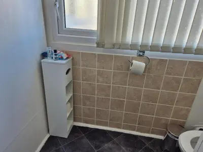a bathroom with a toilet and a window at Glendor Hotel in Blackpool