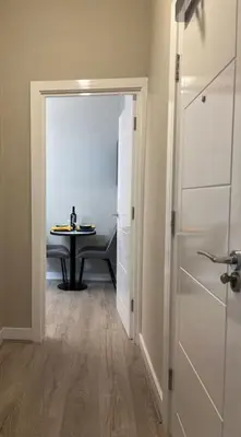 a hallway with a door leading into a room with a table at Gorgeous Quarter House Apartment in Liverpool
