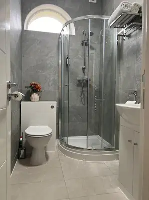 a bathroom with a shower and a toilet and a sink at Gorgeous Quarter House Apartment in Liverpool