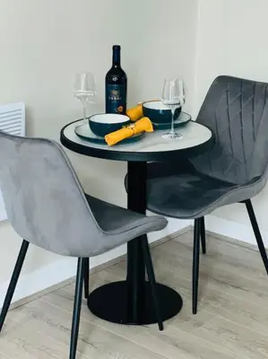 a table with two chairs and a bottle of wine at Gorgeous Quarter House Apartment in Liverpool