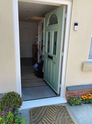 a green door of a house with a hallway at Helens Haven First floor apartment via stairs in Preston