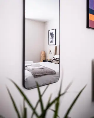 a mirror reflection of a bedroom with a bed in it at Luxury 4BDR House By Torr Property Group Short Lets & Serviced Accommodation With Free Gated Secure Parking & Private Patio Garden Liverpool in Liverpool