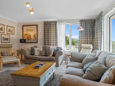 a living room with two couches and a table at Beautiful Detached Property Hot Tub Sauna - Pass the Keys in Lake Side