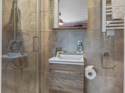a bathroom with a sink and a shower at Beautiful Detached Property Hot Tub Sauna - Pass the Keys in Lake Side