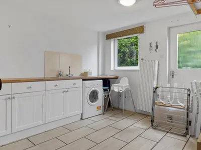 a kitchen with a washing machine and a sink at Beautiful Detached Property Hot Tub Sauna - Pass the Keys in Lake Side