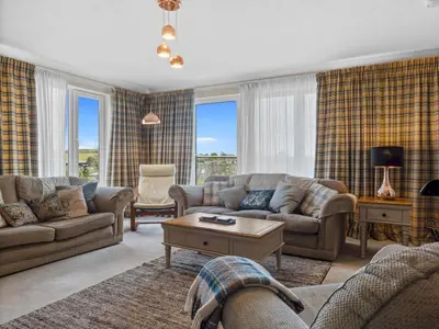 a living room with couches and a table at Beautiful Detached Property Hot Tub Sauna - Pass the Keys in Lake Side