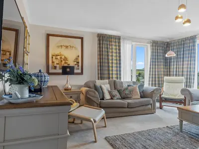 a living room with a couch and a table at Beautiful Detached Property Hot Tub Sauna - Pass the Keys in Lake Side