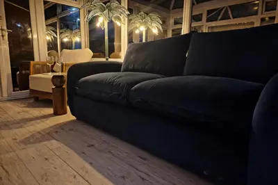 a black couch in a living room with a table at Liverpool House Near City Centre in Liverpool