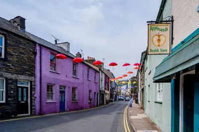 a city street with colorful buildings and umbrellas at 2 Bed in Ulverston oc-q29885 in Ulverston
