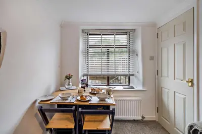 a small kitchen with a table and a window at 2 Bed in Ulverston oc-q29885 in Ulverston