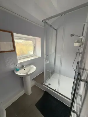 a bathroom with a glass shower and a sink at Suli House-Families and Couples only- 3 minutes' walk to the seafront in Blackpool