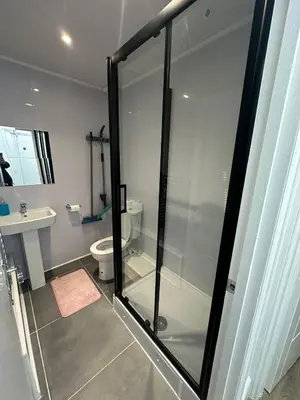 a bathroom with a glass shower and a toilet at Suli House-Families and Couples only- 3 minutes' walk to the seafront in Blackpool