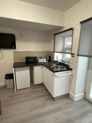 a small kitchen with a sink and a counter at Suli House-Families and Couples only- 3 minutes' walk to the seafront in Blackpool