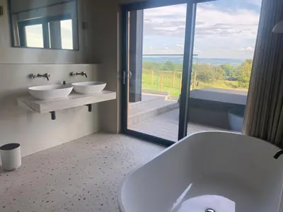 a bathroom with two sinks and a large window at The Lookout in Preston