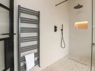 a bathroom with a shower and a mirror at The Lookout in Preston