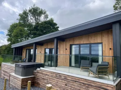 a house with a deck and a grill at The Lookout in Preston