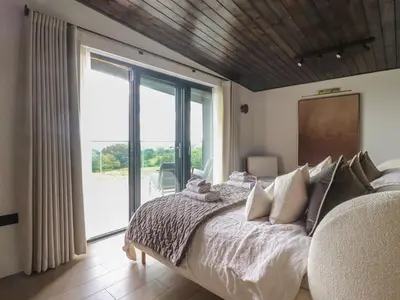 a bedroom with a large bed and a large window at The Lookout in Preston
