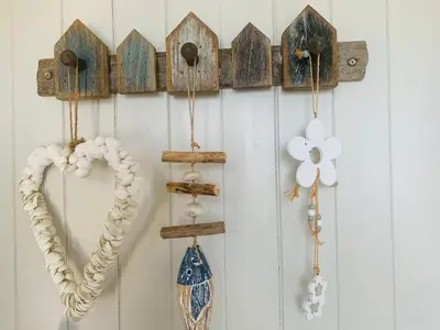 a bunch of wooden birdhouses hanging on a wall at Cockle Bay Cottage in Morecambe