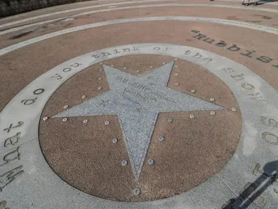 a sign with a star in the middle of a circle at Cockle Bay Cottage in Morecambe