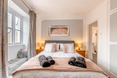 a bedroom with a large bed with two towels on it at 3 Bed in Newton In Cartmel oc-a29796 in High Newton