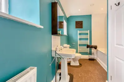 a bathroom with blue walls and a toilet and a sink at 3 Bed in Newton In Cartmel oc-a29796 in High Newton