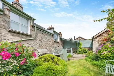 a stone house with a garden and flowers at 3 Bed in Newton In Cartmel oc-a29796 in High Newton