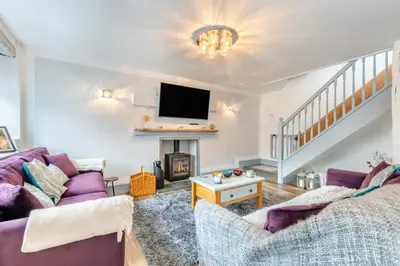 a living room with two purple couches and a fireplace at 3 Bed in Newton In Cartmel oc-a29796 in High Newton