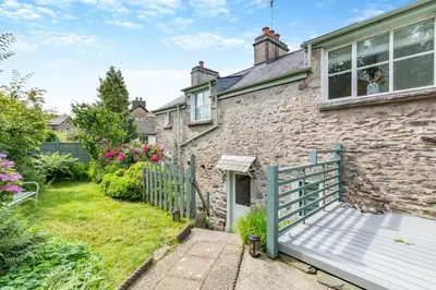 a stone house with a bench in front of it at 3 Bed in Newton In Cartmel oc-a29796 in High Newton
