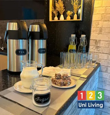 a counter with a coffee maker and plates of food at Leatham Park Hotel Blackpool in Blackpool